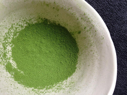 Swirld of a beautiful Matcha blend in a pretty ceramic cup.