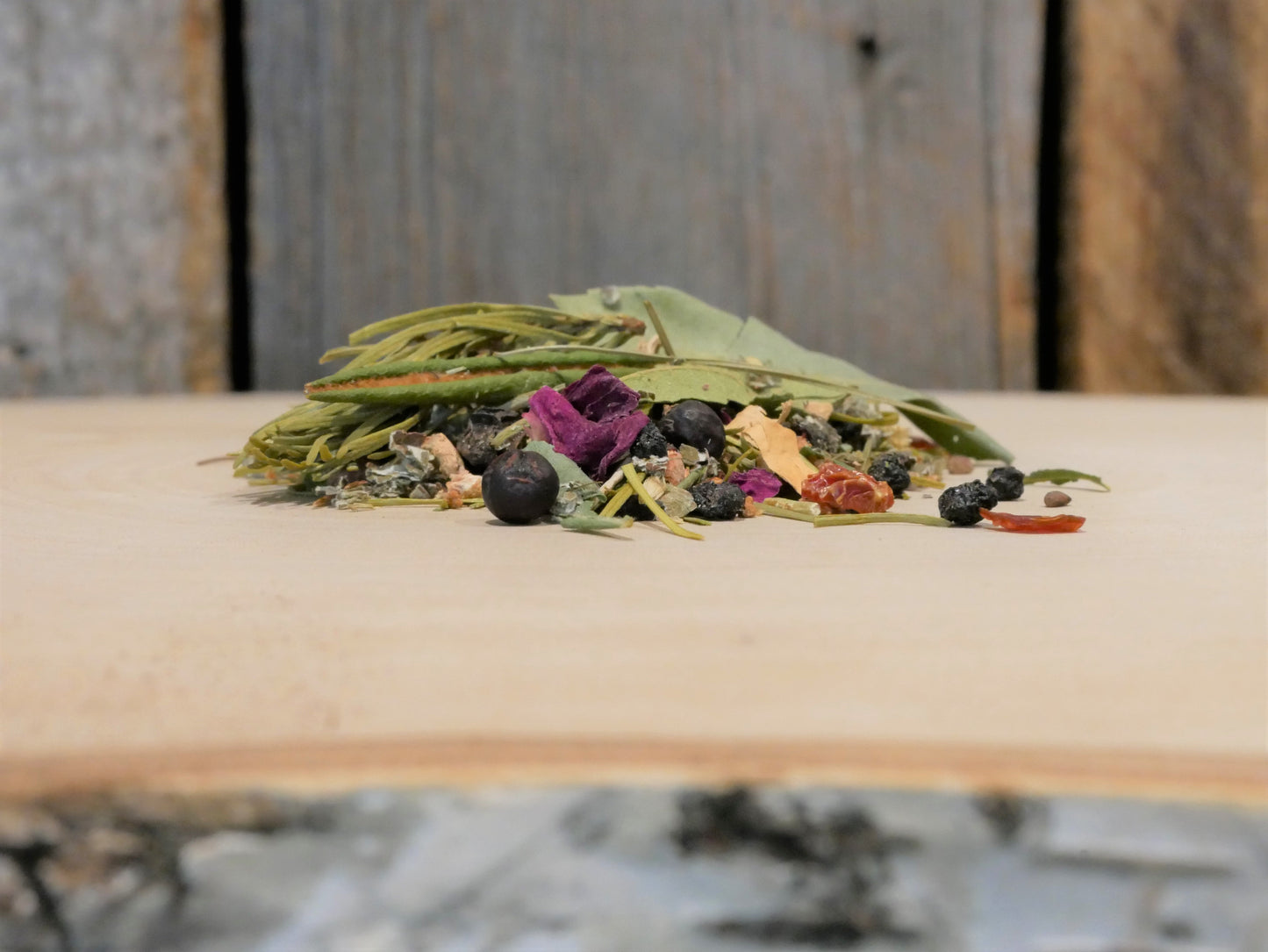 View of a Cabin Tea Wild tisane on birch tree with barn wood background.