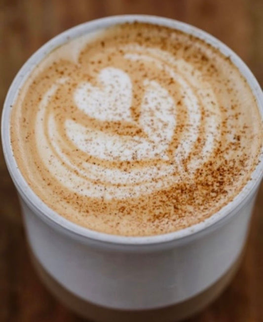 Cup of Chai Pow latte flower art made by a barista.