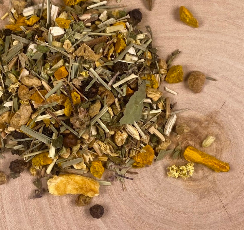 Pile of tea on a birch tree slab with turmeric with a mix of herbal.