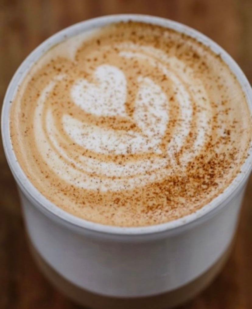 Cup of Chai Pow latte flower art made by a barista.